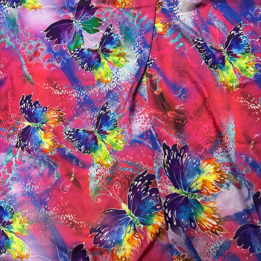Pink butterfly print silk touch satin fabric with purple, blue, yellow and green butterflies - Bullring Fabrics