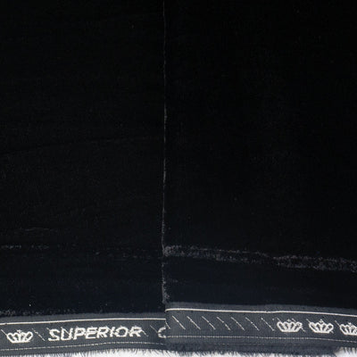 Close-up of a black fabric material with a white stitched border and the word 'SUPERIOR' printed along the edge, alongside small crown motifs.