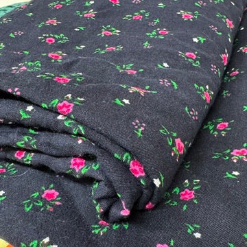 Navy floral viscose fabric folded to show drape - image 4