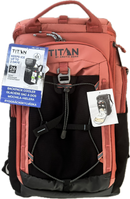 A Titan by Arctic Zone backpack in terracotta pink and black, shown with its included cooler accessory packaging and an informational hangtag against a plain white background.