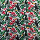 Tropical fabric pattern with toucans, pink flowers, and green leaves on a white background