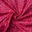Red fabric with black leopard print pattern Rose and Hubble 