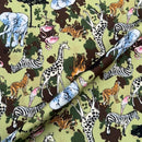 Fabric with safari-themed animal pattern on a green background