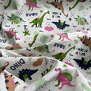 Dinosaur-themed fabric with colorful dinosaurs and text on a Ivory background
