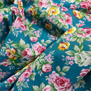 Floral fabric with pink, yellow, and green flowers on a blue background