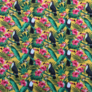 Tropical pattern with toucans, pink flowers, and green leaves on a yellow background