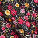 Black fabric with a dense, colorful floral print featuring pink, red, yellow, and white flowers with green and beige leaves, shown in soft folds.