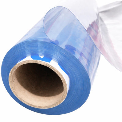 A roll of glossy transparent blue film or vinyl, partially unrolled to show its clear backing, wound around a brown cardboard core against a white background.