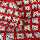 Tissu en polycoton de Noël avec des timbres de Père Noël 
