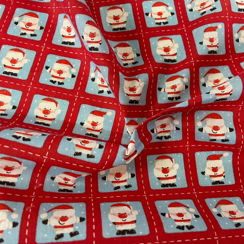 Tissu en polycoton de Noël avec des timbres de Père Noël 