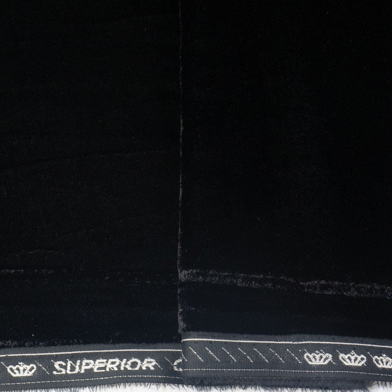 Close-up of a black fabric material with a white stitched border and the word 'SUPERIOR' printed along the edge, alongside small crown motifs.
