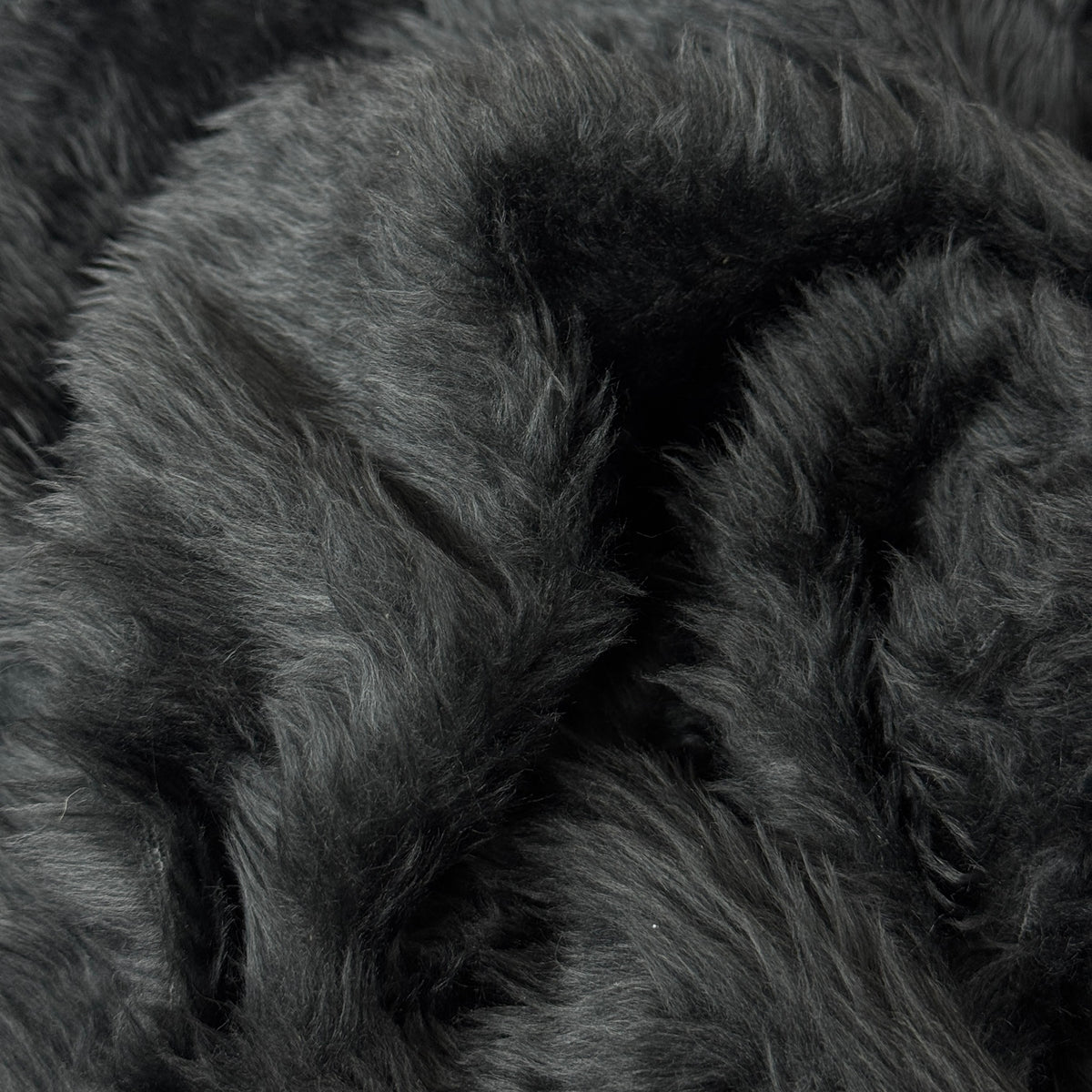 Dark charcoal grey fur fabric gathered to show soft pile - image 3